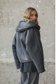 A short gray sheepskin coat with a hood made of natural sheepskin