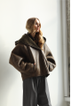 Short sheepskin coat with a chocolate-colored hood made of natural sheepskin