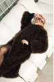 Long women's chocolate-colored fur coat made of cashmere goat