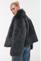 Short double-sided sheepskin coat in gray color made of cashmere lamb