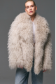 Stylish fur coat made of natural llama in beige color