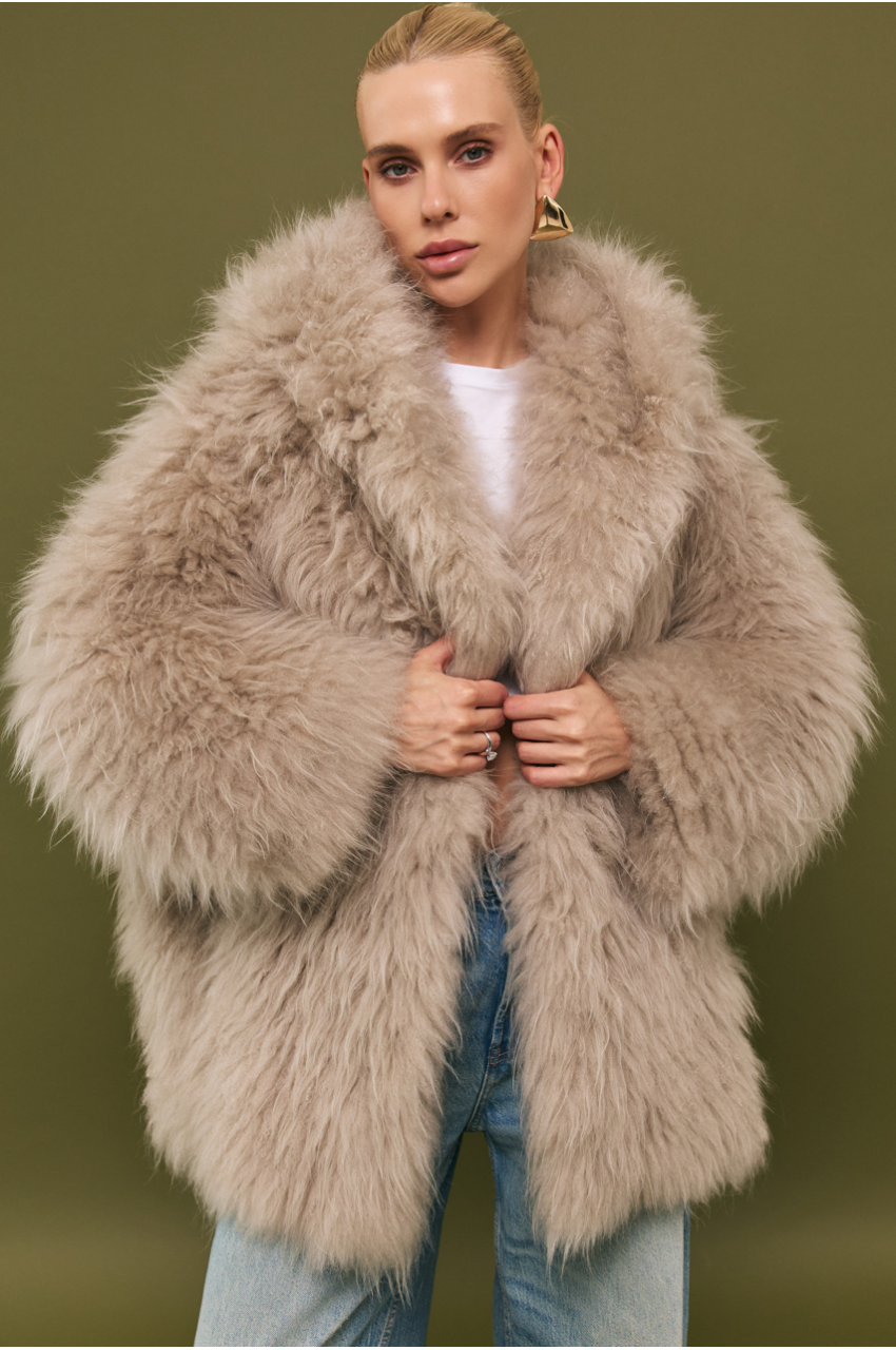 Women's fur coat made of natural cashmere goatskin in beige color