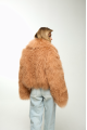 Caramel-colored women's sheepskin coat made of natural llama