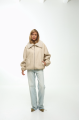 A short milk-colored bomber jacket made of natural sheepskin