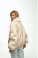 A short milk-colored bomber jacket made of natural sheepskin