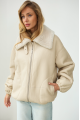 A short milk-colored bomber jacket made of natural sheepskin