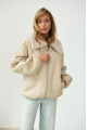 A short milk-colored bomber jacket made of natural sheepskin