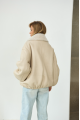 A short milk-colored bomber jacket made of natural sheepskin