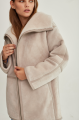 Women's sheepskin coat of beige color made of natural sheepskin