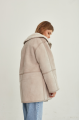 Women's sheepskin coat of beige color made of natural sheepskin