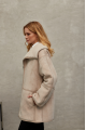 Women's sheepskin coat of beige color made of natural sheepskin