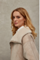 Women's sheepskin coat of beige color made of natural sheepskin