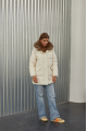 Women's down jacket of white color with a hare fur trim