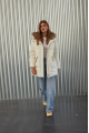 Women's down jacket of white color with a hare fur trim