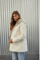 Women's down jacket of white color with a hare fur trim