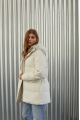 Women's down jacket of white color with a hare fur trim