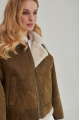 Women's short sheepskin coat made of natural sheepskin in a vintage style in brown color