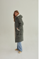 Stylish green women's down jacket with natural filler and sheepskin fur trim