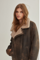 Women's sheepskin coat of brown color in American vintage style