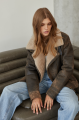 Women's sheepskin coat of brown color in American vintage style