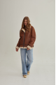 A stylish vintage sheepskin coat made of natural sheepskin in the color of whiskey