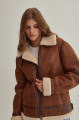 A stylish vintage sheepskin coat made of natural sheepskin in the color of whiskey