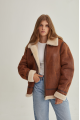 A stylish vintage sheepskin coat made of natural sheepskin in the color of whiskey