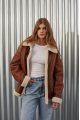 A stylish vintage sheepskin coat made of natural sheepskin in the color of whiskey