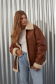 A stylish vintage sheepskin coat made of natural sheepskin in the color of whiskey