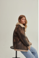 Women's sheepskin coat of brown color in vintage style