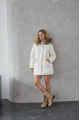 Women's down jacket of white color with a hare fur trim