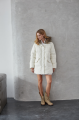 Women's down jacket of white color with a hare fur trim