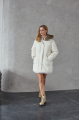 Women's down jacket of white color with a hare fur trim