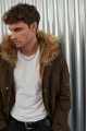 Men's parka of brown color with raccoon fur