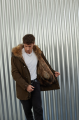 Men's parka of brown color with raccoon fur