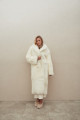 Long sheepskin coat made of natural cashmere lamb in beige color