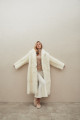 Long sheepskin coat made of natural cashmere lamb in beige color