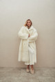 Long sheepskin coat made of natural cashmere lamb in beige color