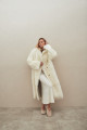 Long sheepskin coat made of natural cashmere lamb in beige color