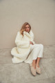 Long sheepskin coat made of natural cashmere lamb in beige color