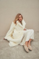 Long sheepskin coat made of natural cashmere lamb in beige color