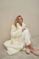 Long sheepskin coat made of natural cashmere lamb in beige color