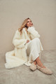 Long sheepskin coat made of natural cashmere lamb in beige color