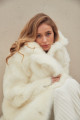 Long sheepskin coat made of natural cashmere lamb in beige color