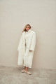 Long sheepskin coat made of natural cashmere lamb in beige color