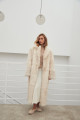 Long sheepskin coat made of natural cashmere lamb in beige color