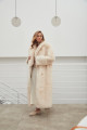 Long sheepskin coat made of natural cashmere lamb in beige color