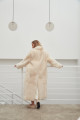 Long sheepskin coat made of natural cashmere lamb in beige color