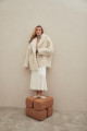 Curly double-sided sheepskin coat of white color made of natural sheepskin in the OVERSIZE style