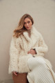 Curly double-sided sheepskin coat of white color made of natural sheepskin in the OVERSIZE style